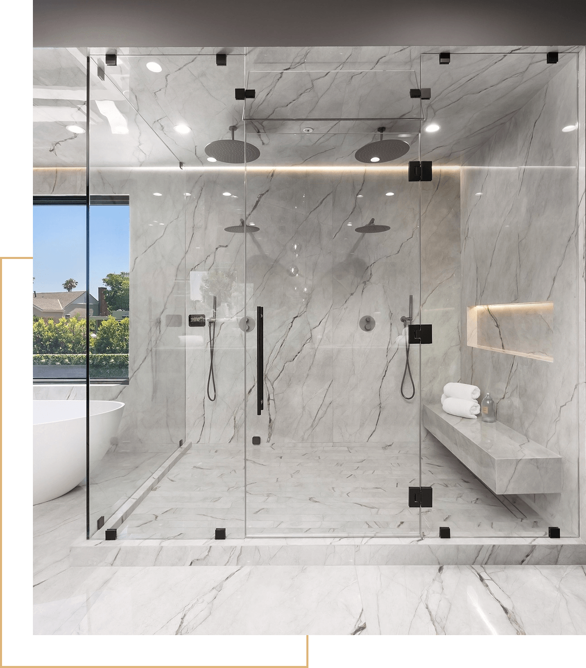 Luxurious marble shower with glass enclosure.