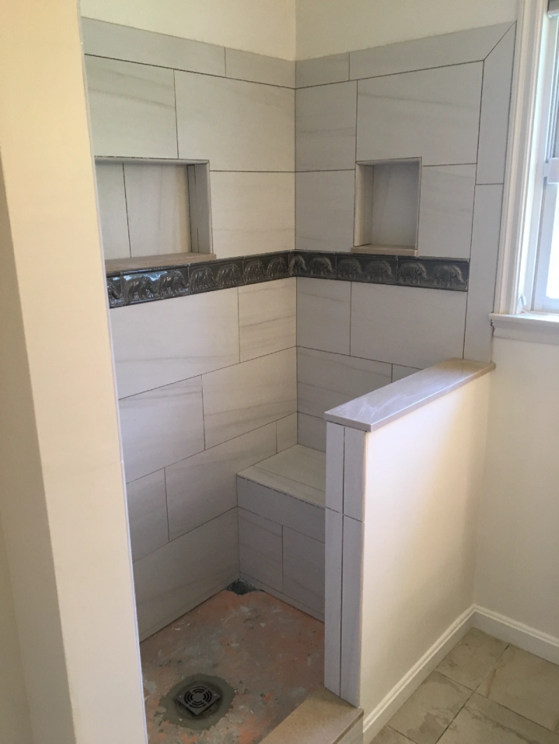 Close-up of custom white bathroom wall panels in a home.