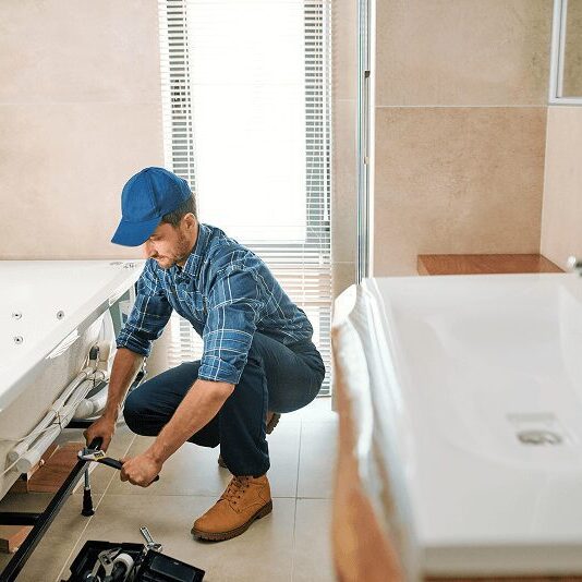 Our staff doing bathroom repairs at a client's home in NH.