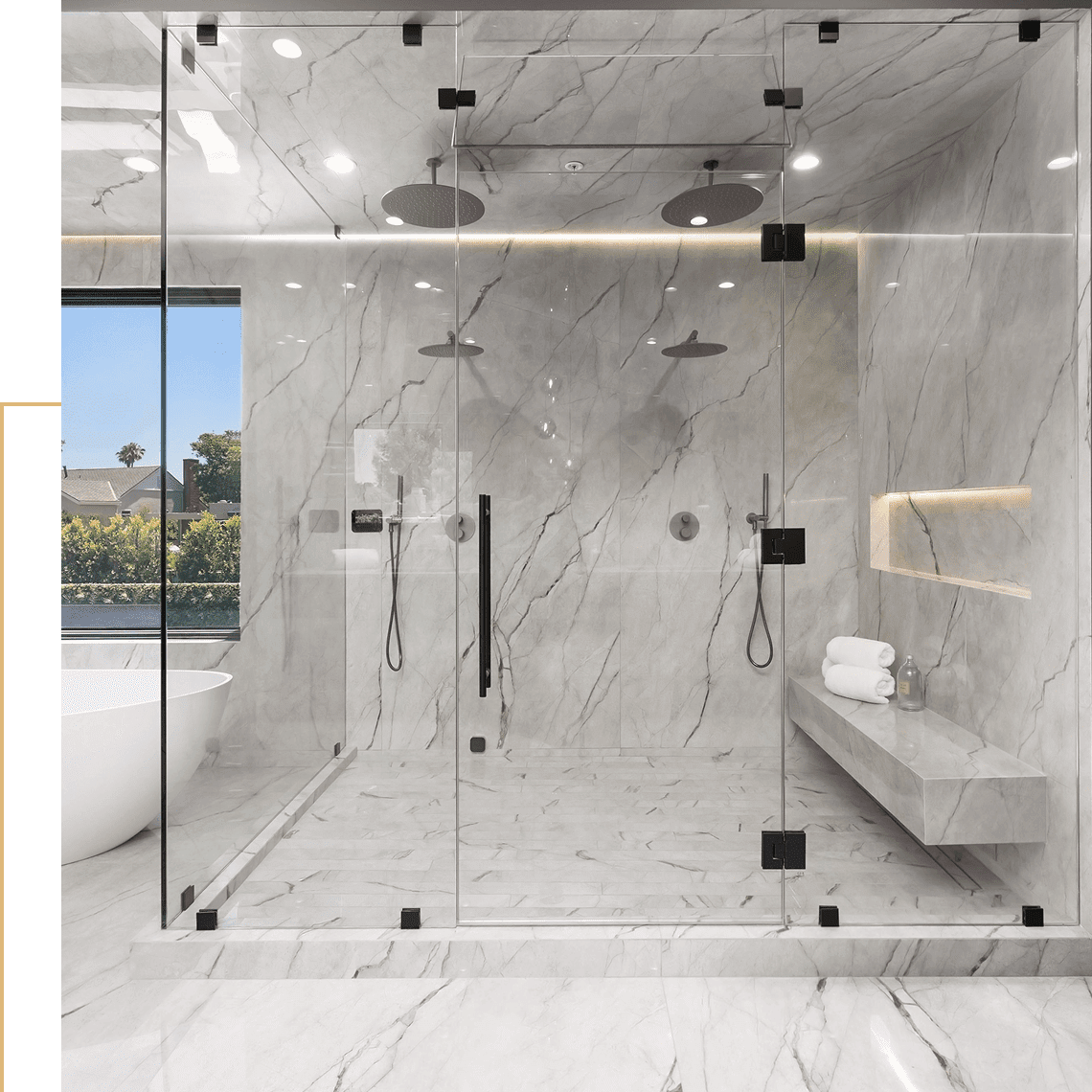 Luxurious marble shower with glass enclosure.