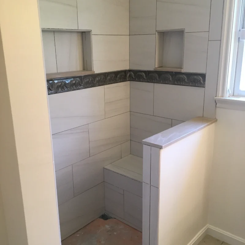 Close-up of custom white bathroom wall panels in a home.